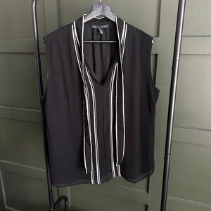 Black sleeveless blouse with white detail and a built in tie